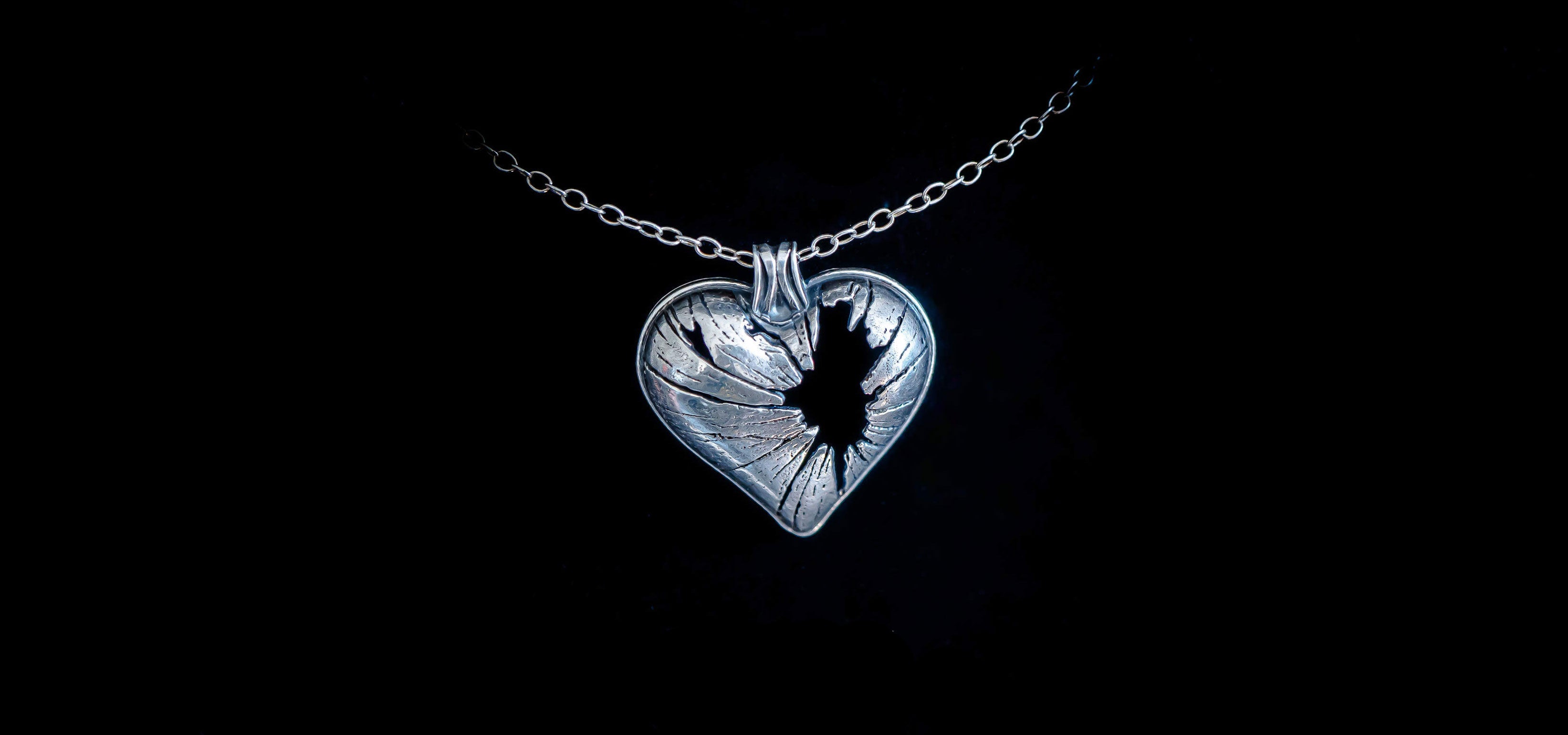 shatter-broken-heart-pendant---faceless-jewelry---sterling-silver-gothic-jewelry314wide.jpg__PID:f37fceaa-7b5f-4bcd-b401-3e9cbc8cc2b8