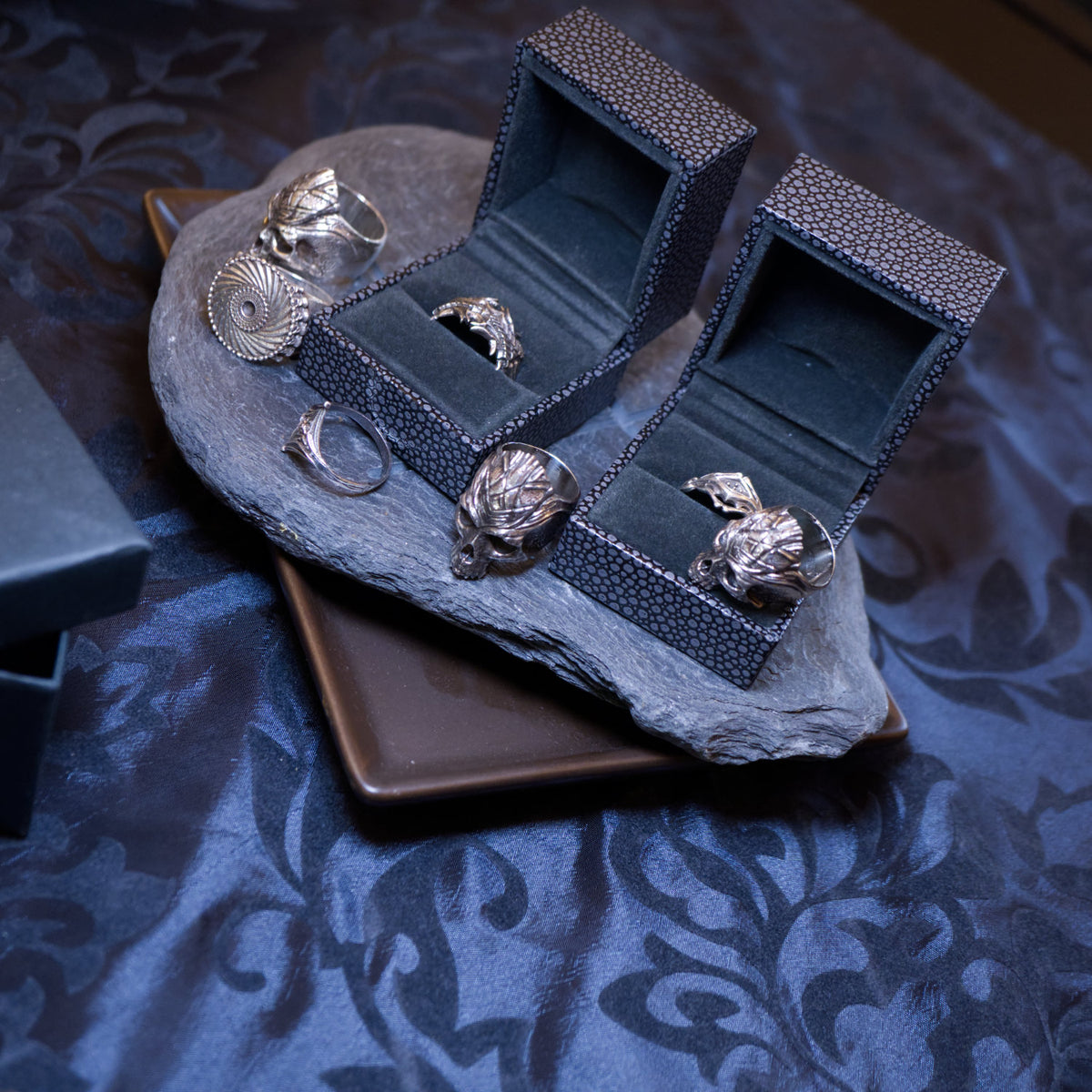 photograph of sterling silver gothic rings on table 