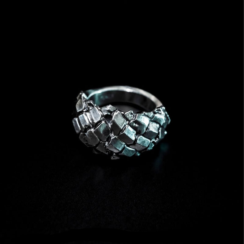 silver ring with abstract flowing plates sculpted across the form